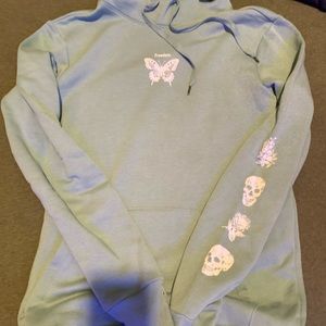 Teal hoodie with print on front and sleeve